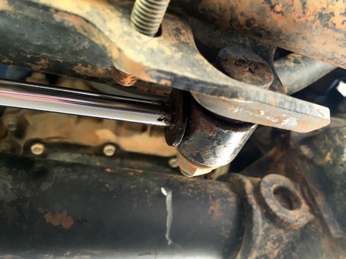 The OEM stabilizer shock is held on by bolts at the track bar bracket and a stud attached to the tie rod.